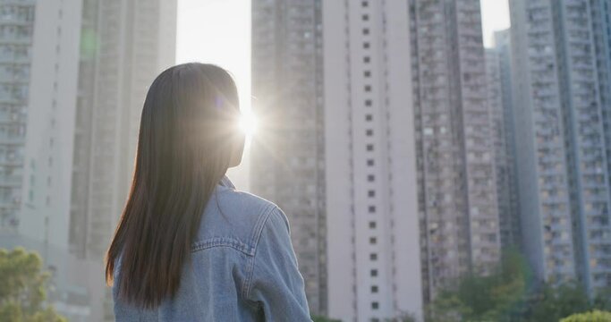 Woman look at the building with sunlight flare