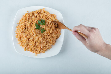 Delicious bulgur pilaf on a white plate