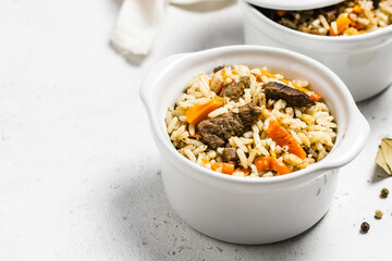 Rice pilaf with orzo and meat in pots. Space for text.