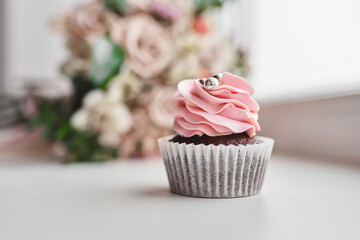 Sweet wedding cake on the background of the bride's bouquet