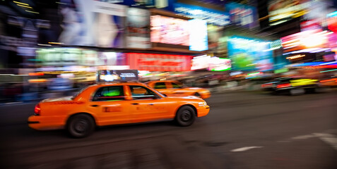 Yellow Taxi in Manhattan, New York City  in USA with blur technique