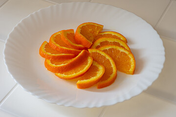 close up of fresh oranges slices on a plate 