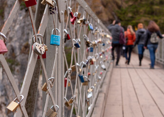 wedding locks hanging on the iron fence of the bridge