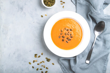 Autumn pumpkin cream soup with seeds is healthy organic vegetarian food