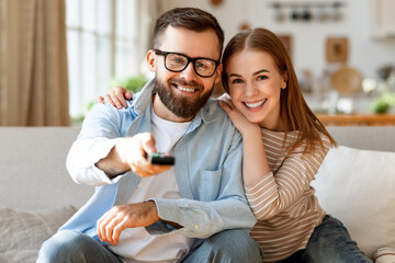 Happy couple watching TV together