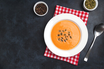 Autumn pumpkin cream soup with seeds is healthy organic vegetarian food