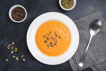 Autumn pumpkin cream soup with seeds is healthy organic vegetarian food