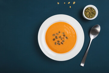 Autumn pumpkin cream soup with seeds is healthy organic vegetarian food