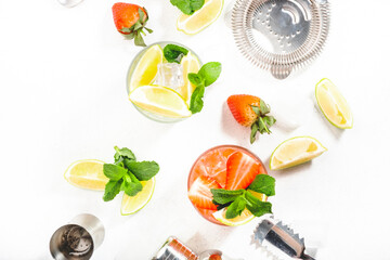 Mojito mocktail set with lime, mint, strawberry and ice on white background. Cold alcoholic...