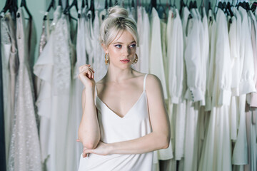 Portrait of young and beautiful blond girl, in one nightie. Look to the side.