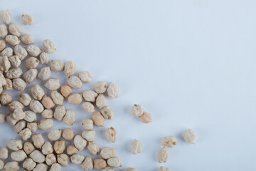 Fototapeta na wymiar Some of white unprepared peas on a white background