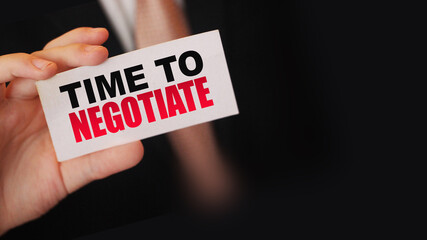 Time to negotiate words on a card in businessman's pocket. Compromise in business concept