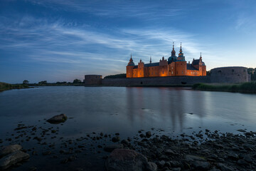 Kalmar Castle in Sweden at sunset with a moonlit summer sky