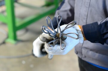 Workers are making braided wire rope for installation at the transport elevator.