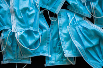 Used blue surgical protective masks. Pollution by surgical masks during the coronavirus pandemic. Covid-19 plastic waste and garbage, disposable masks.