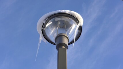 lamppost of the light lying frozen due to the polar cold in Saint Moritz Swiss - winter artic polar temperature in mountain 