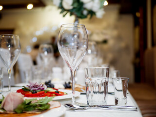 Served for a banquet table. Wine glasses with napkins, glasses and salads.