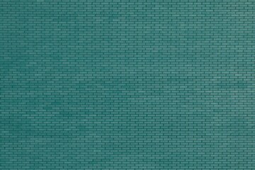 The wall is tiled with brick-like tiles.