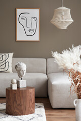 Stylish interior with design neutral modular sofa, mock up poster frames, coffee tables, dried flowers, decoration, pendant lamp and elegant personal accessories in modern home decor. Template.