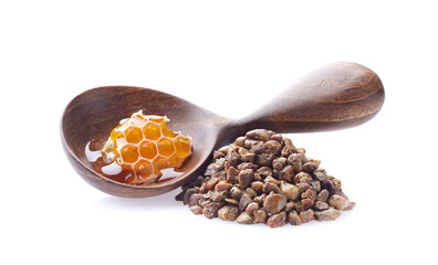 Propolis granules and wooden spoon with honeycomb on white background.
