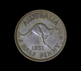 Back of a 1951 Australian Brown Half Penny coin on black background