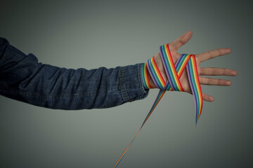 man hand with a rainbow ribbon