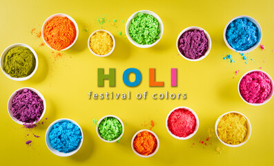 Happy holi festival decoration.Top view of colorful holi powder on yellow  background with copy space for text.