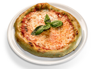 Green pizza with colored dough with spinach. topped with mozzarella, tomato and basil leaves. isolated on white