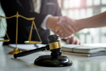Businessman shaking hands to seal a deal with his partner lawyers or attorneys discussing a contract agreement.