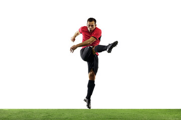 Fototapeta na wymiar Powerful, flying above the field. Young football, soccer player in action, motion isolated on white background with green grass. Concept of sport, movement, energy and dynamic, healthy lifestyle.