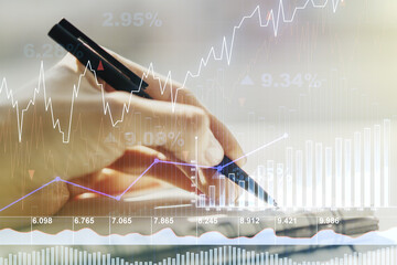 Multi exposure of abstract financial graph with hand writing in notebook on background, financial and trading concept