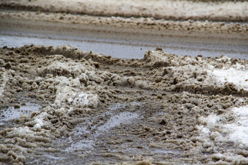 The dirty road with snow in the city Sumy in Ukraine