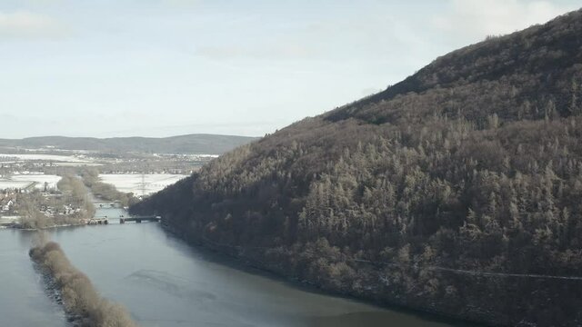 Drone Aerial views of the Keller National Park in Winter. The barrier lake Edersee is partly frozen. The Ederstausee is located in Hesse near the town Waldeck in Germany, Europe.