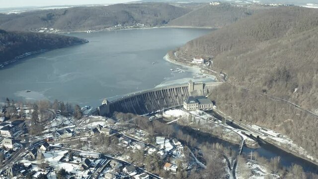Drone Aerial views of the Keller National Park in Winter. The barrier lake Edersee is partly frozen. The Ederstausee is located in Hesse near the town Waldeck in Germany, Europe.