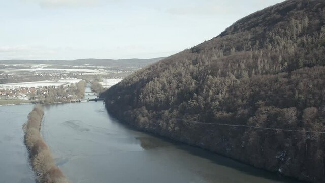 Drone Aerial views of the Keller National Park in Winter. The barrier lake Edersee is partly frozen. The Ederstausee is located in Hesse near the town Waldeck in Germany, Europe.
