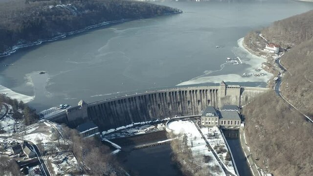 Drone Aerial views of the Keller National Park in Winter. The barrier lake Edersee is partly frozen. The Ederstausee is located in Hesse near the town Waldeck in Germany, Europe.