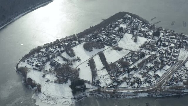 Drone Aerial views of the Keller National Park in Winter. The barrier lake Edersee is partly frozen. The Ederstausee is located in Hesse near the town Waldeck in Germany, Europe.