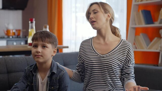 The little boy is hurt by his mother. She doesn't care when her mother screams and pisses off at her. Angry mother scolding a disobedient child. Mom and child quarrel conception.