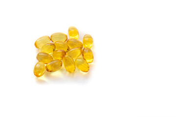 Shiny yellow fish oil capsules isolated on a white background. Vitamin E. Copy space for your text