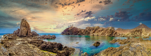 Panoramic view from the Arrecife de las Sirenas in Cabo de Gata, Spain. Sunset in Seascape with reefs and clouds - obrazy, fototapety, plakaty