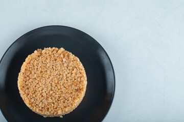 Delicious bulgur pilaf on a dark plate