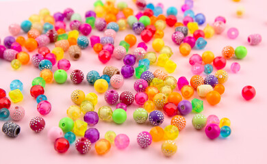 Combination of beads and beads on a pink background.