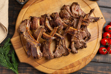 Roast rack of lamb served on wooden board