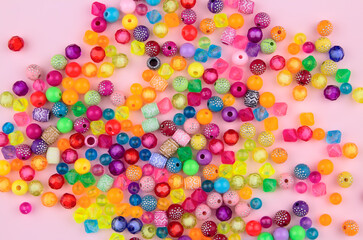 Combination of beads and beads on a pink background.