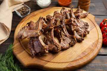 Roast rack of lamb served on wooden board