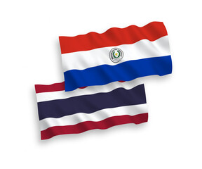 National vector fabric wave flags of Paraguay and Thailand isolated on white background. 1 to 2 proportion.