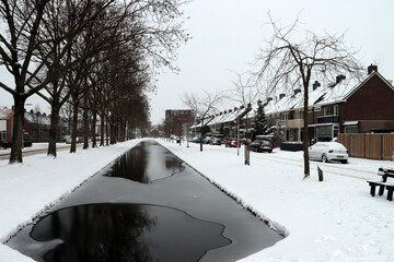 Snow on the streets and frozen water during the winter of 2021 in Nieuwerkerk