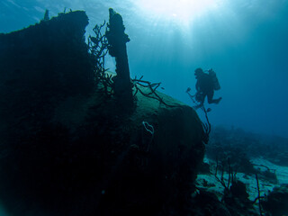 Low Angle Shot Of One Scuba Diver Photograph The Sunken Shipwreck In Caribbean Sea At Sunny Summer. - 416037255
