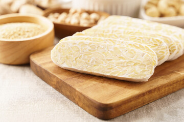 Sliced homemade traditional tempeh an Indonesian food made from fermented soybeans which is one of the healthiest alternative plant protein for Vegan and Plant-based diet. Probiotics, Non-GMOs