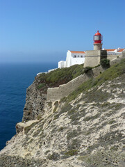 Fototapeta na wymiar Sagres (Algarve) Portugal. Perspective of the Cape of San Vicente with the lighthouse in the first place.